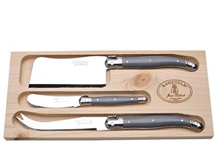 Side angle view of Laguiole cheese knives showing the signature bee emblem detail