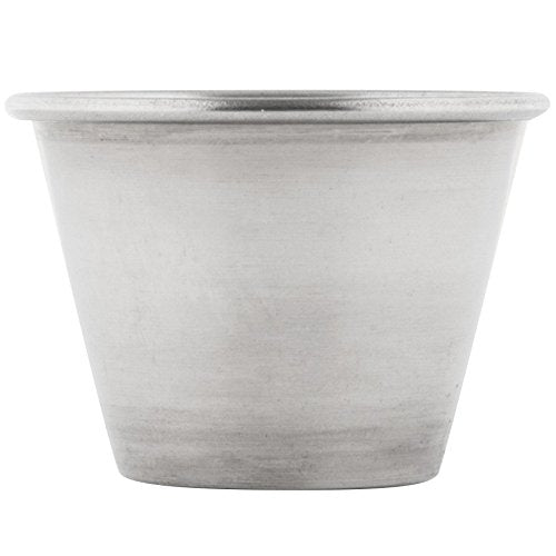 Stainless steel 2.5 oz sauce cups styled on a dinner table alongside plated food