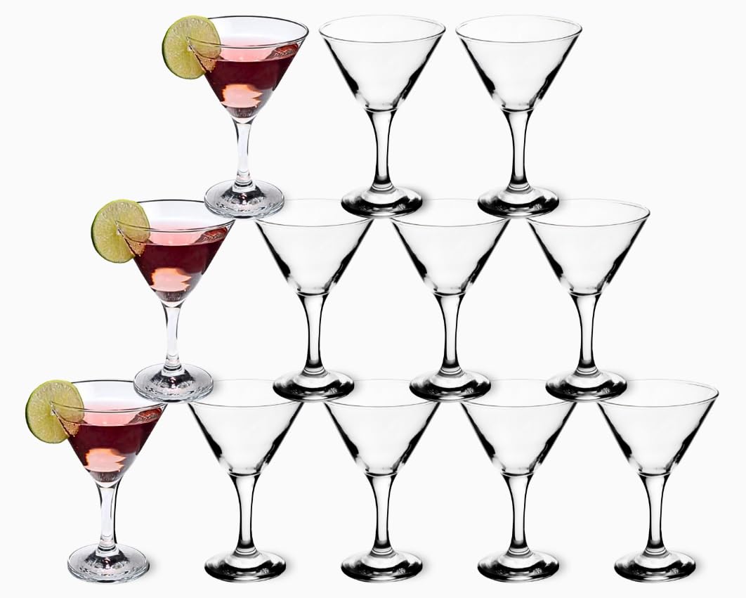 Crystal stemmed martini glass alongside fresh lime and cocktail shaker