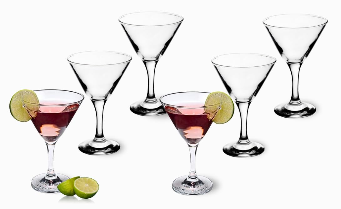 Martini glasses arranged on a home bar cart with cocktail accessories