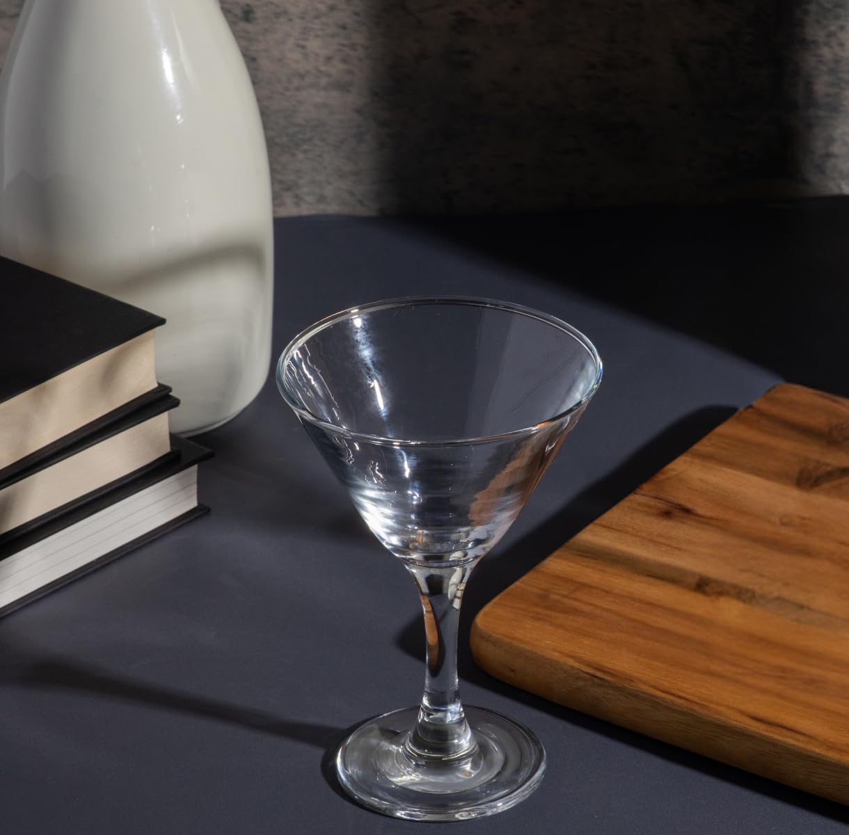 Stemmed martini glass held in hand to show scale and size reference