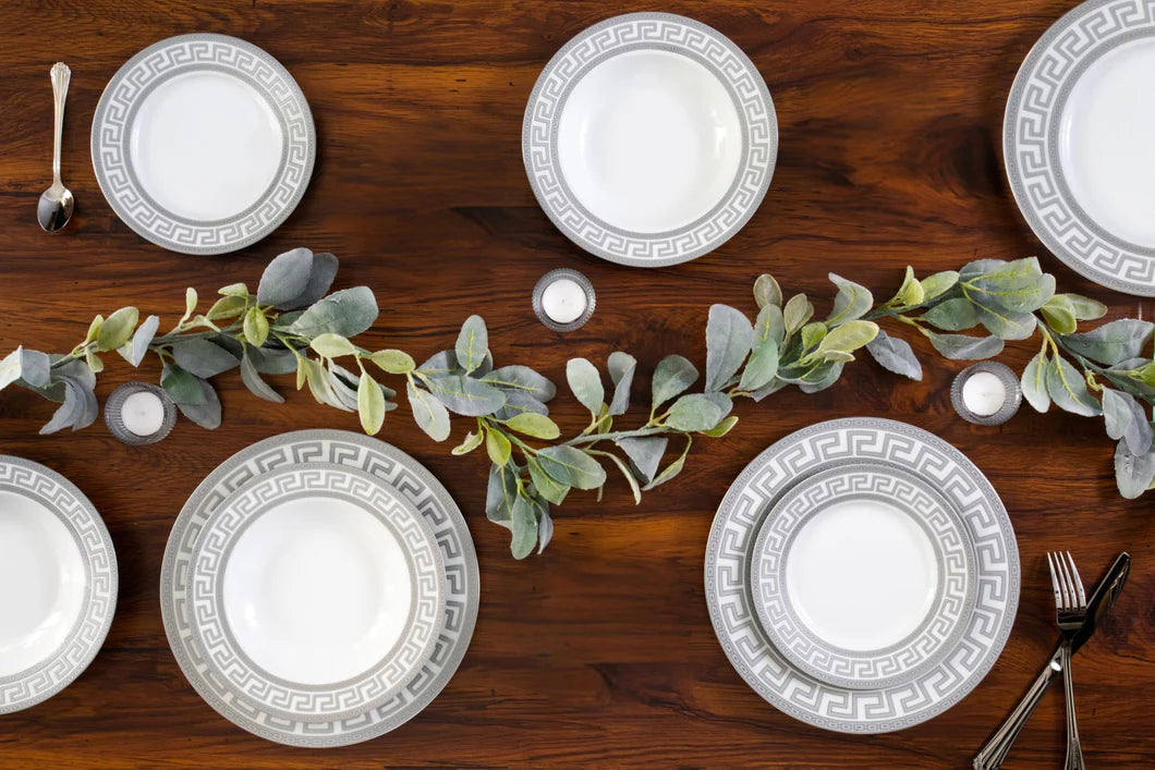 Angled side view of the vintage porcelain dinner plates showing the elegant rim profile and glaze finish