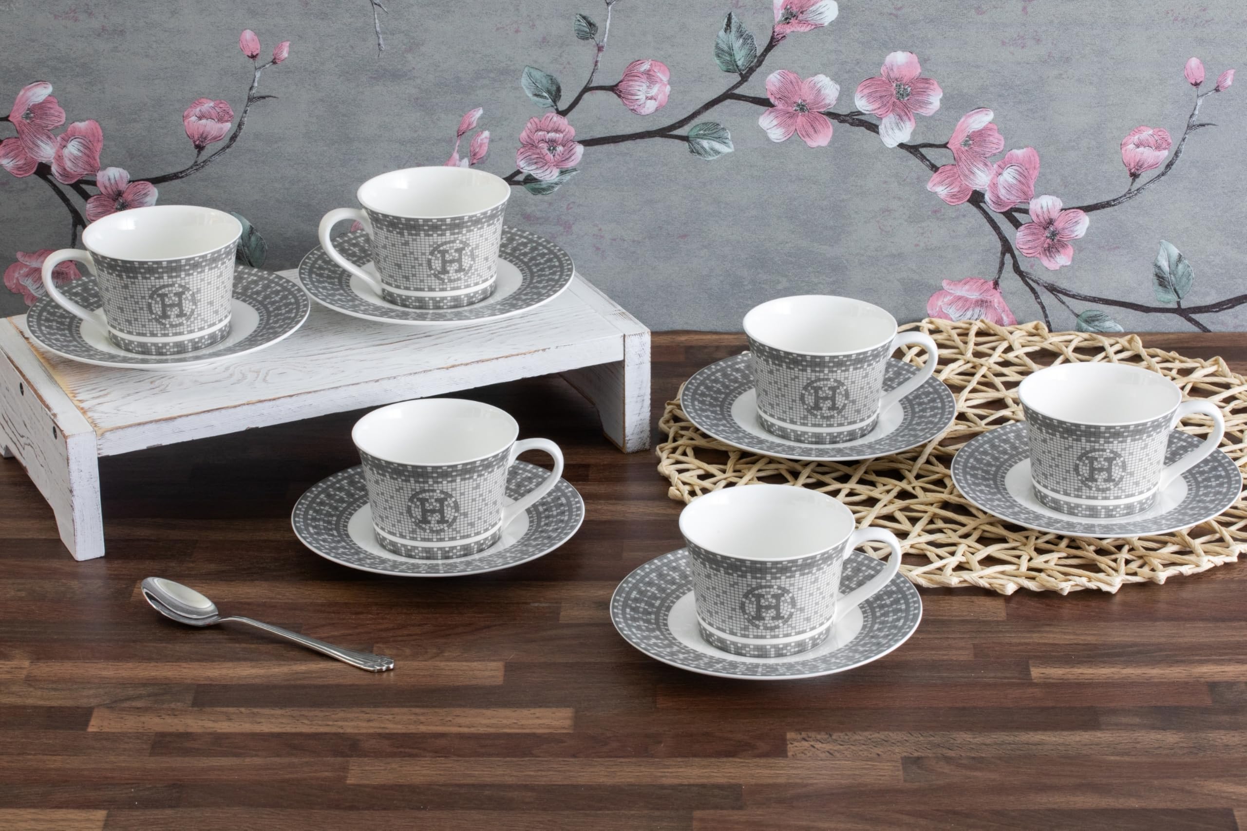 Porcelain tea cup and saucer styled on a decorated table set for an elegant afternoon tea