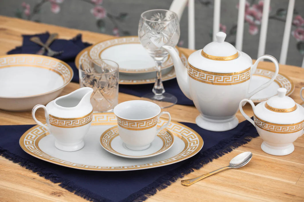 Full 57-piece porcelain dinnerware set laid out showing all plates, bowls, cups, saucers, and accessories