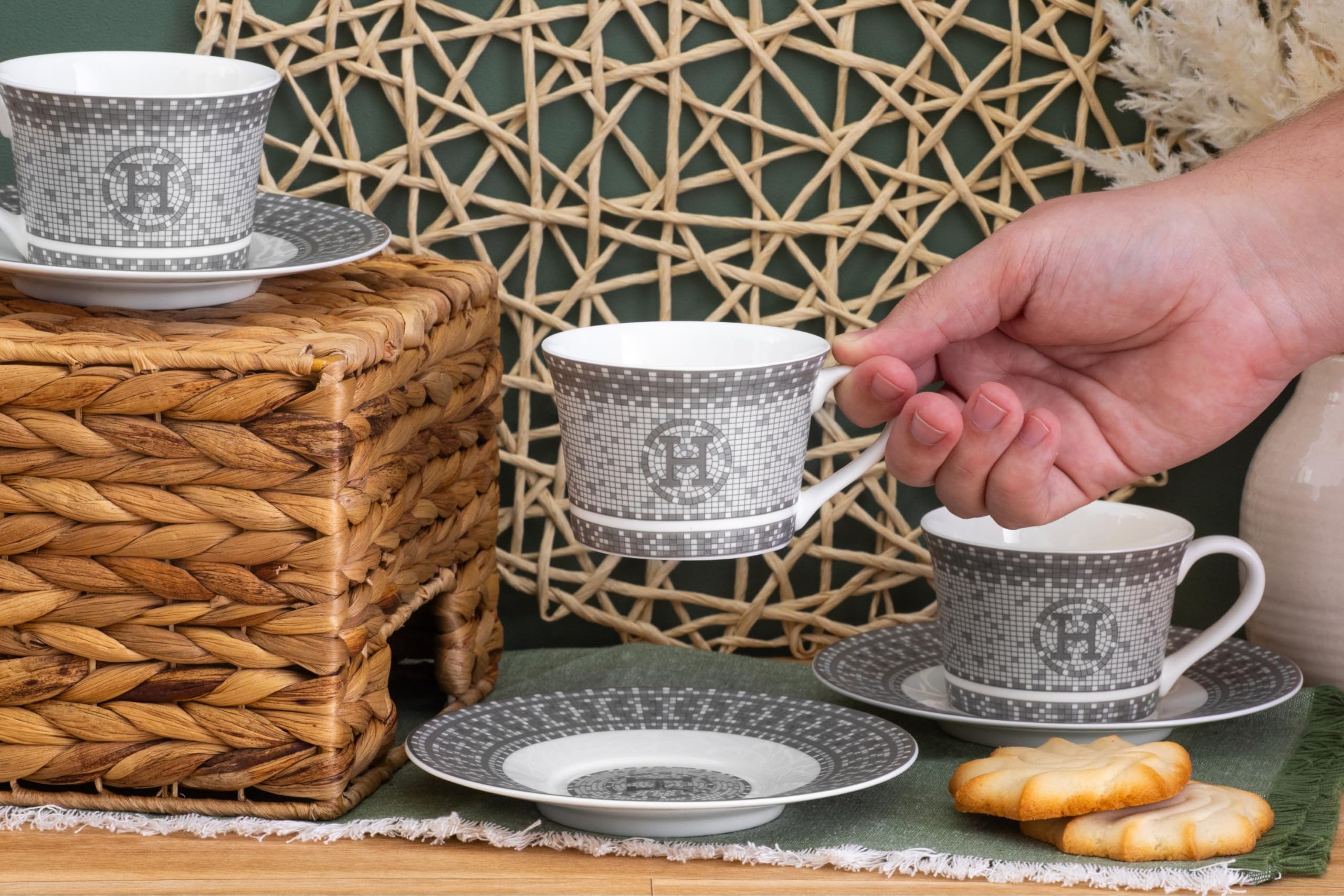 Single porcelain tea cup beside its matching saucer highlighting the 6 oz capacity and fine craftsmanship