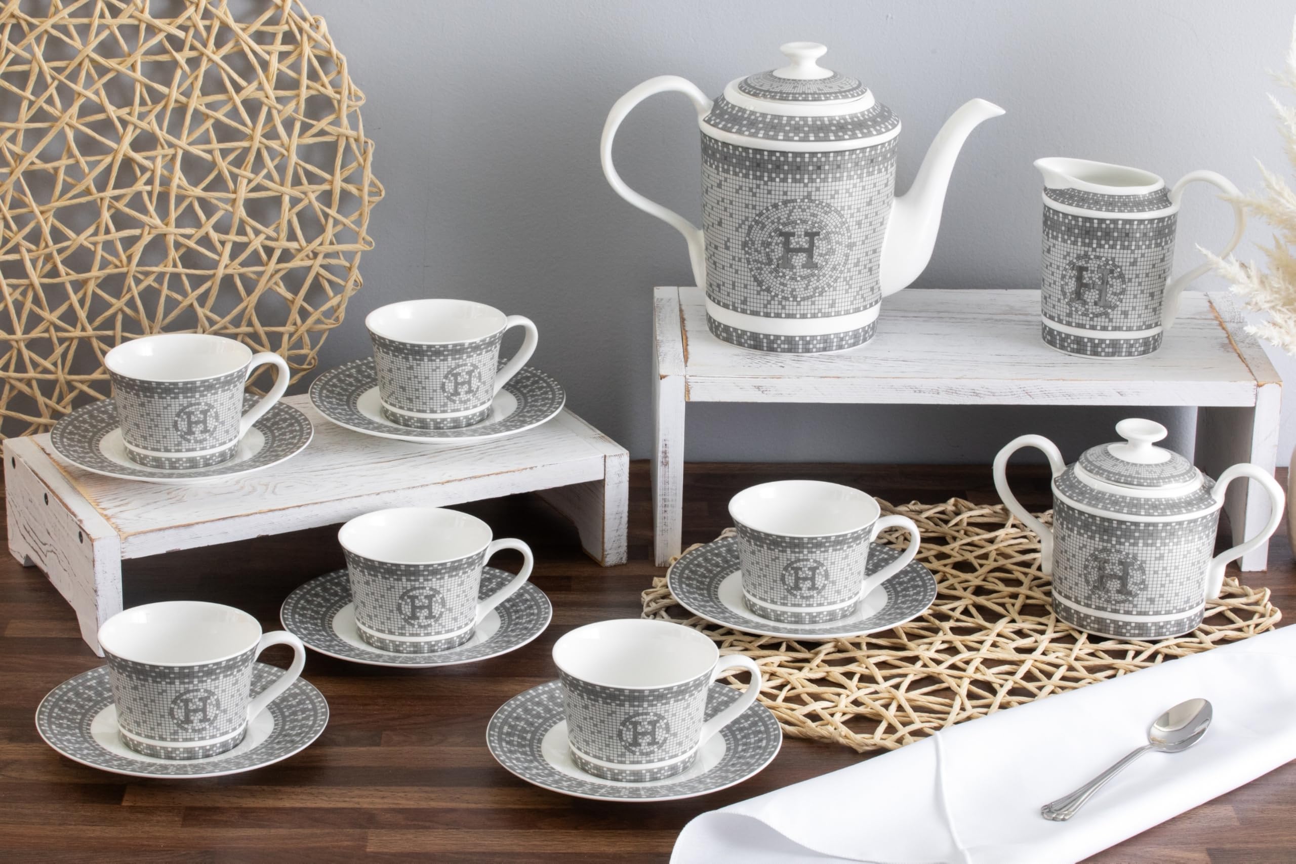 Six porcelain tea cups and saucers arranged together showcasing the complete service for six