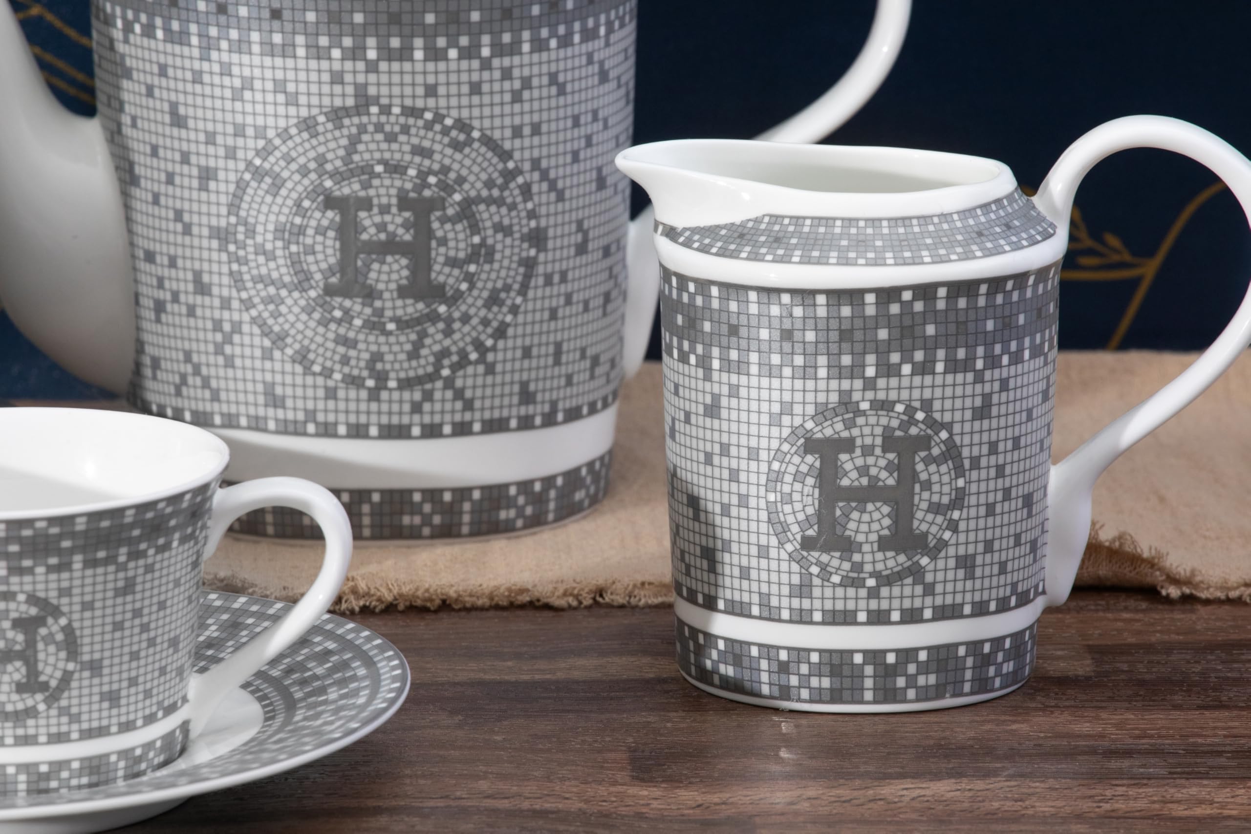 Individual 6 oz porcelain tea cup and saucer showing mosaic pattern and silver rim accent