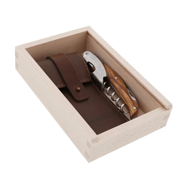 Laguiole classic corkscrew styled on a wooden surface beside a wine bottle, shown in an entertaining context