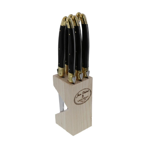 Laguiole steak knife set in wooden block shown as part of a formal table setting
