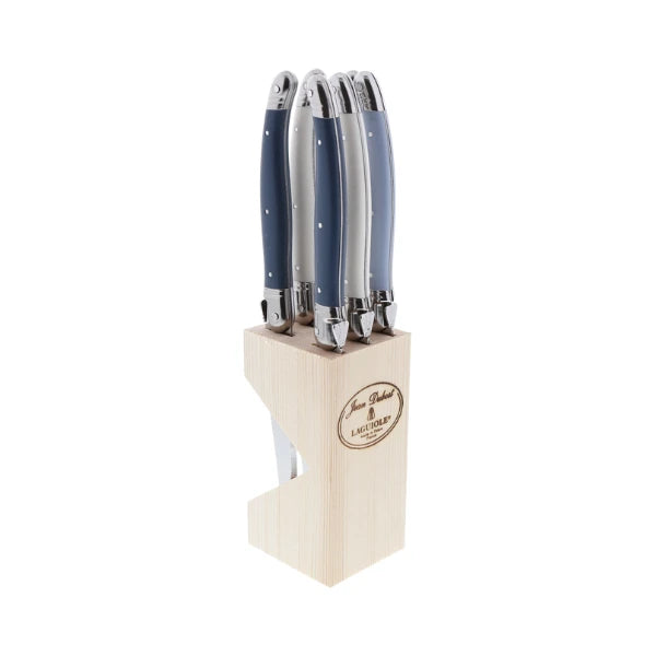 Single Laguiole steak knife held over a plated steak at a styled dinner table
