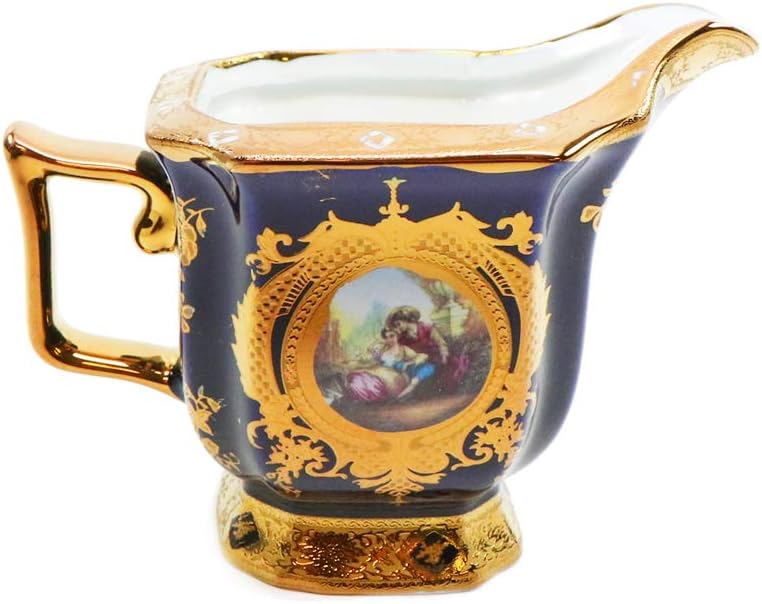 Close-up of hand-painted blue and gold ceramic motif on a Royalty Porcelain tea cup and saucer