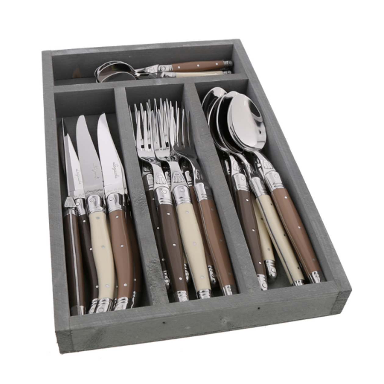 Flatware set styled on a fully set dining table with plates, glasses, and linen napkins