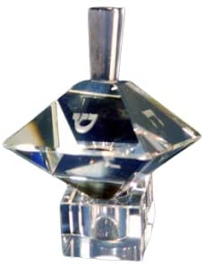 Double pyramid crystal dreidel with etched Hebrew letters, reflecting light against a clean background