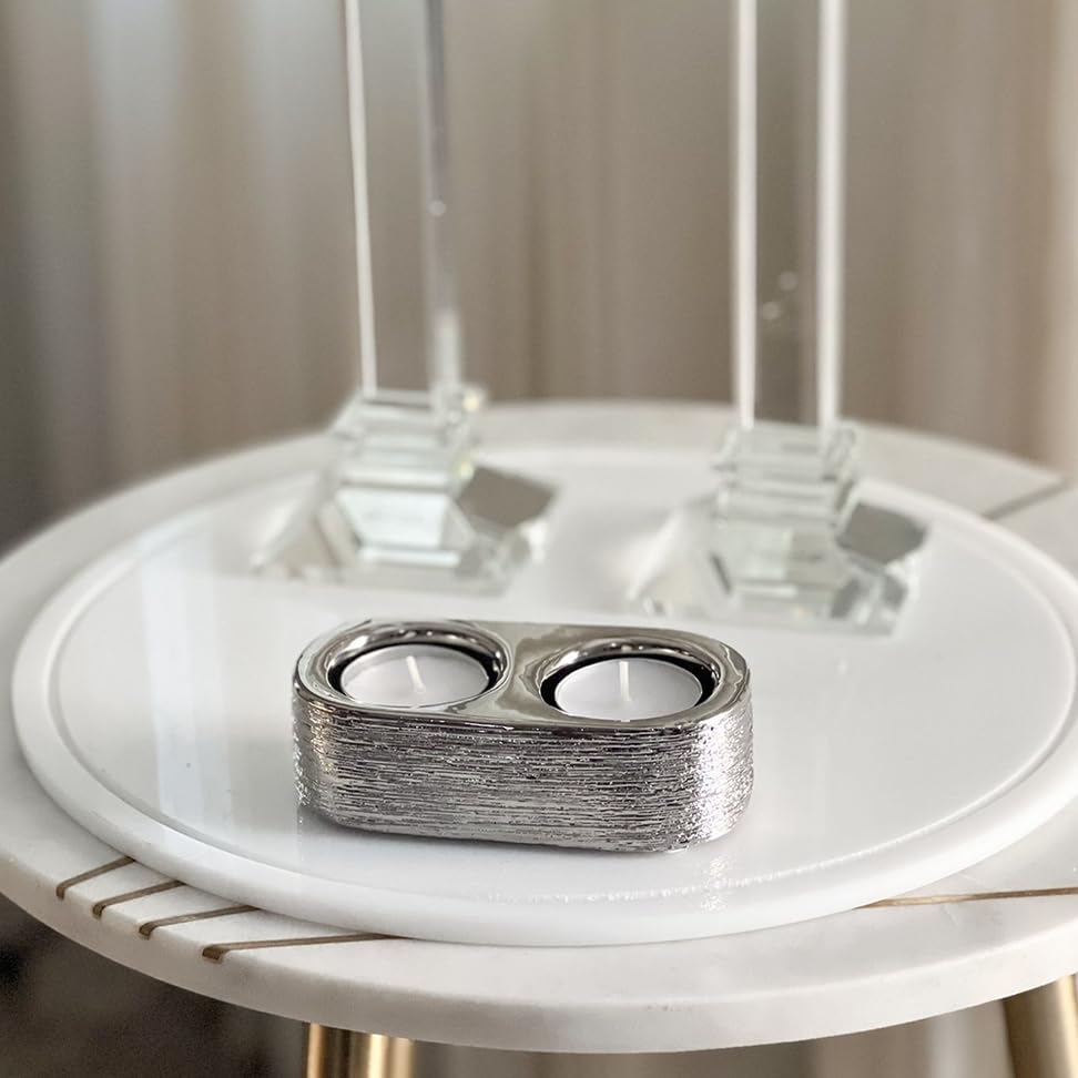 Close-up of the embossed silver finish and tealight wells on the decorative double holder